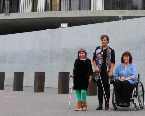 Members of the disability community Esther Woodbury, Helena Tuteao and Gerri Pomeroy outside Parliament.